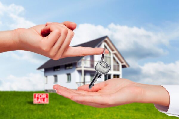 hands holding home keys